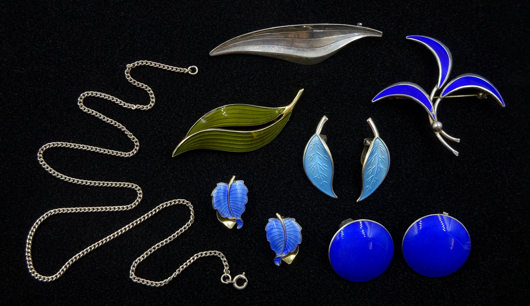  Norwegian and Danish silver and enamel jewellery including David Anderson leaf clip earrings, Aksel Holmsen leaf brooch, Einar Modahl circular clip earrings, silver brooch by Hermann Siersbol, pair of clip earrings, brooch and silver chain  