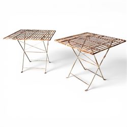 Pair of French 1920's wrought metal folding bistro café tables, the strapwork top over a f...