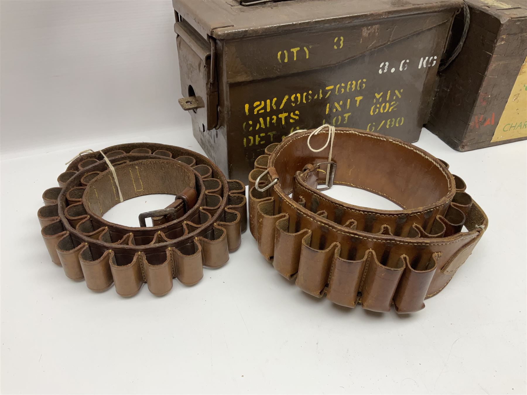 Miscellaneous shooting accessories - W.J. Bowman & Sons clay pigeon launcher; two leather cartridge belts; three cartridge bags; two canvas/leather game bags; and two metal/wooden cartridge boxes