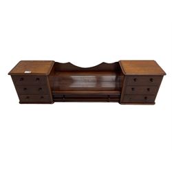 Victorian mahogany correspondence or trinket stand, two banks of three small drawers flanking long central drawer