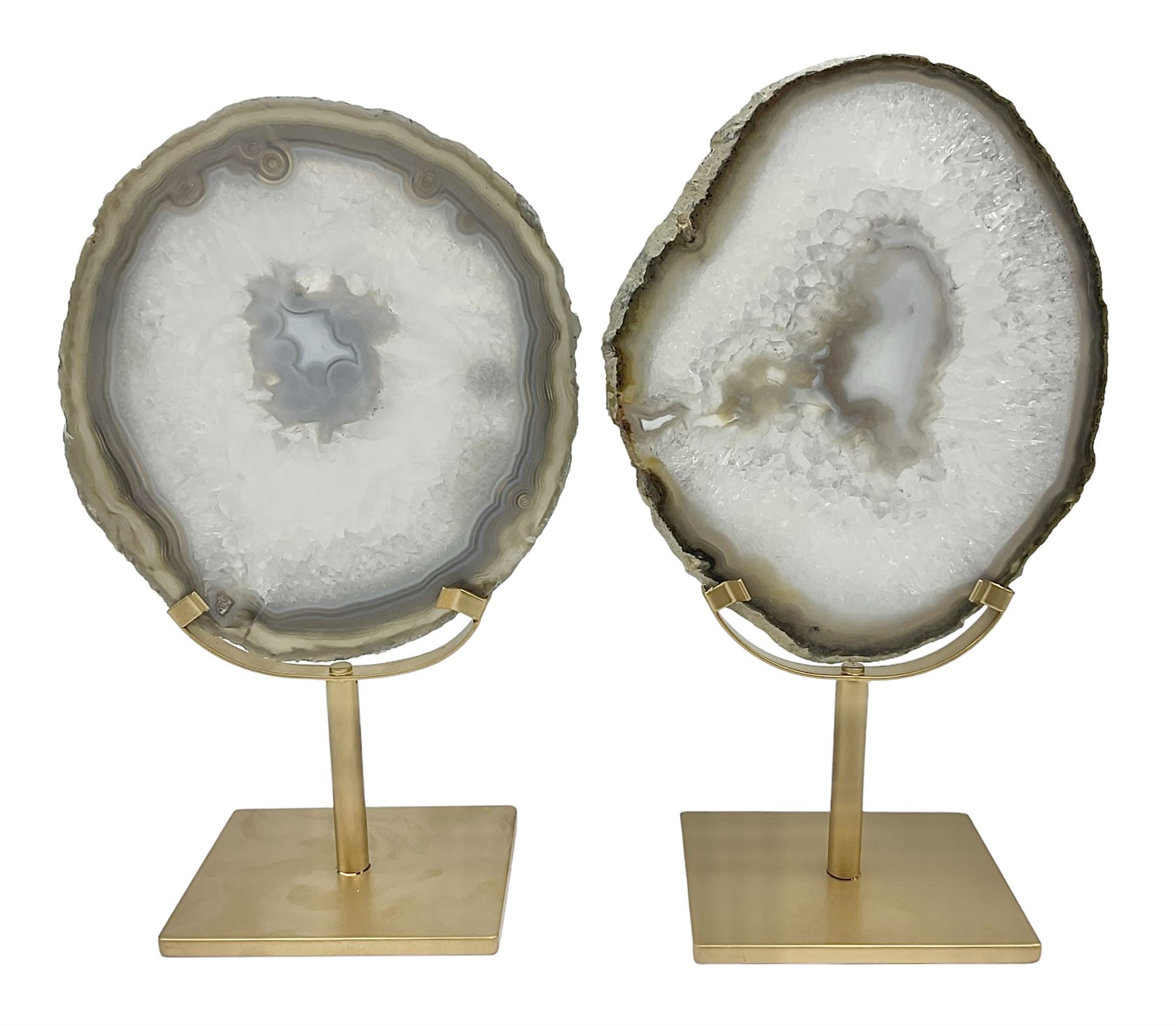 Pair of white agate slices, polished with rough edges raised upon gilt metal stands, H24cm