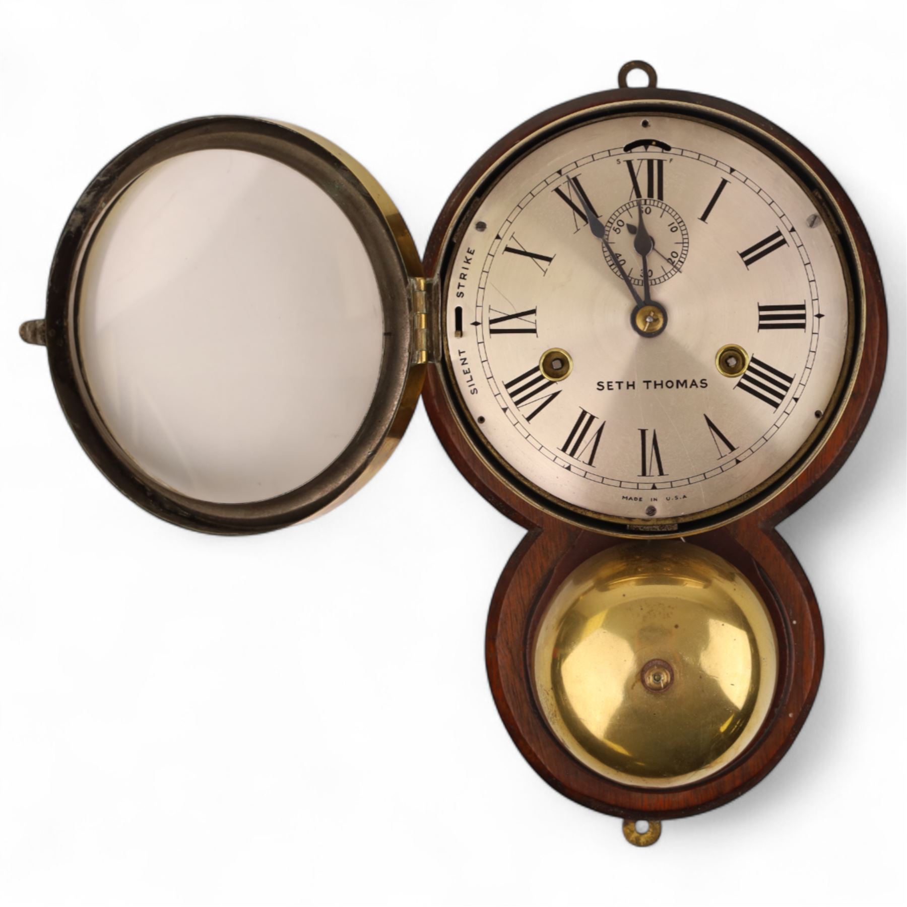 Seth Thomas U.S.A. Ships clock, circa1890, silvered dial with Roman numerals, steel spade hands and subsidiary seconds dial, with a circular alloy drum case mounted on a wooden plaque