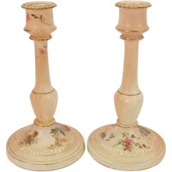 Royal Worcester blush ivory dressing table set, decorated with flowers, comprising an oval tray, three covered pots and a pair of candlesticks 