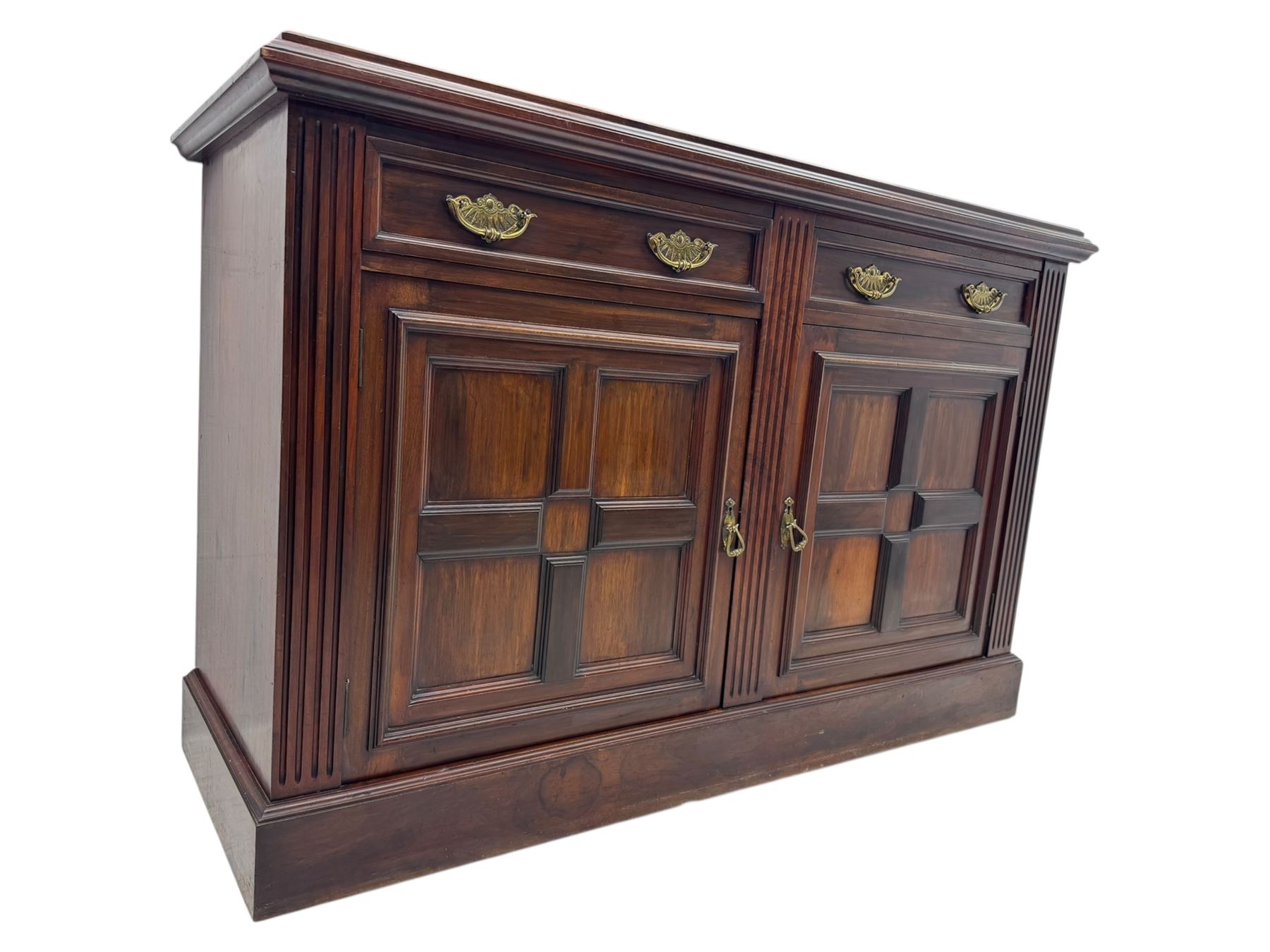 Victorian mirror back press, the arched corniced mirror back flanked by half columns, the base fitted with three drawers and four moulded panel doors with geometric detail, on a block plinth