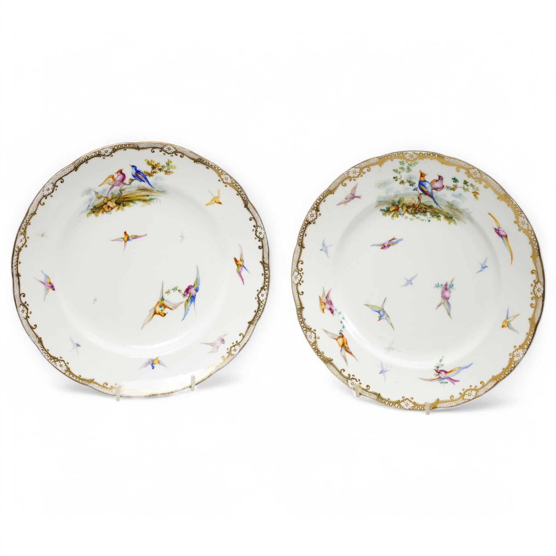 Pair of Coalport cabinet plates, c1850, painted by John Randall with various exotic birds in flight within gilt trailing foliate boarders, D23cm 