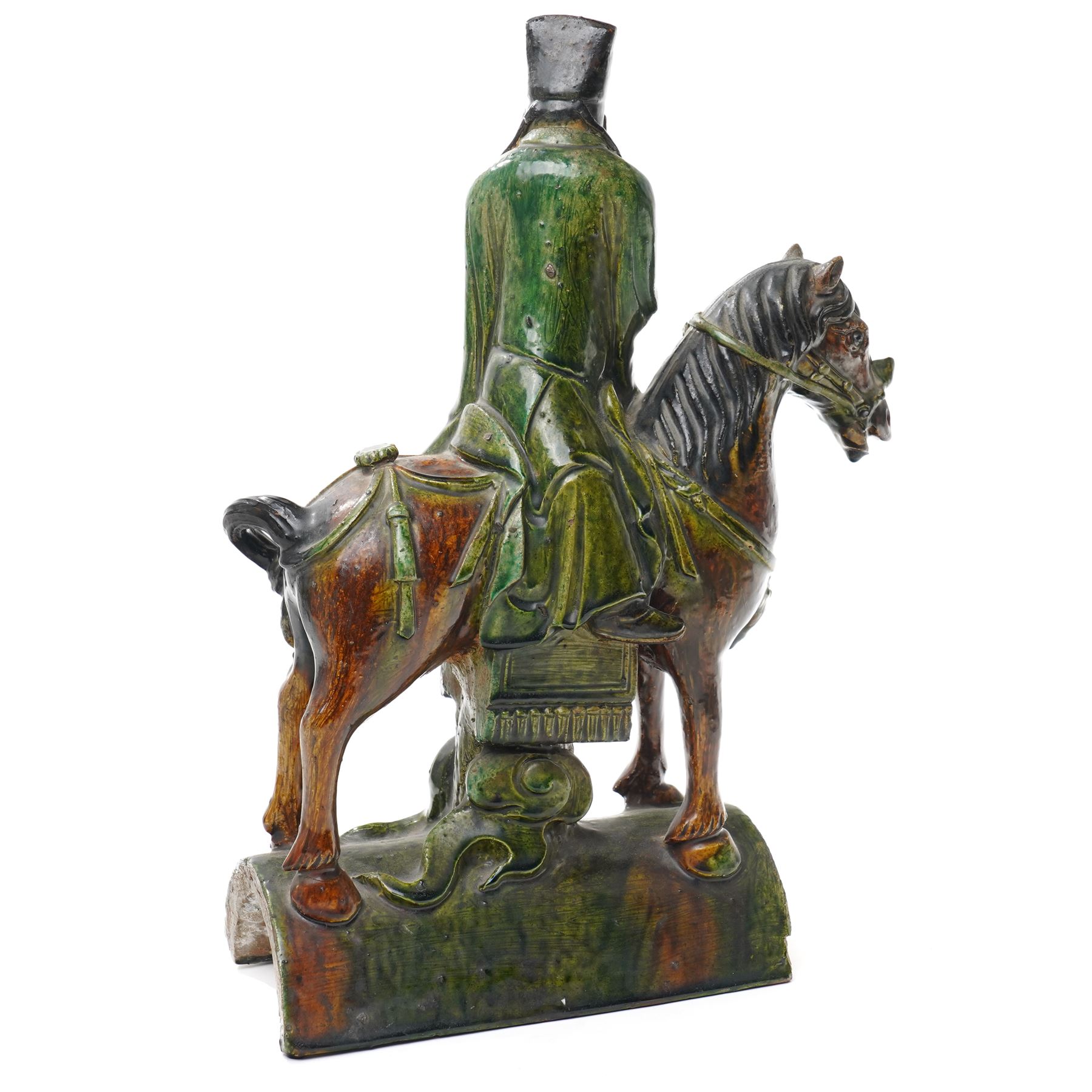 Chinese Ming dynasty Sancai Glazed Roof Tile, modelled as a dignitary on horseback, dressed in a long robe with voluminous folds, wearing an official's cap, upon a half cylinder tile, H40cm