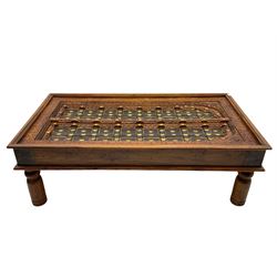 Eastern hardwood door coffee table, decorated with foliate carving and metal work, turned supports