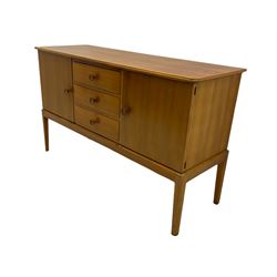 Gordon Russell - mid century walnut sideboard, fitted with three drawers, and two cupboards