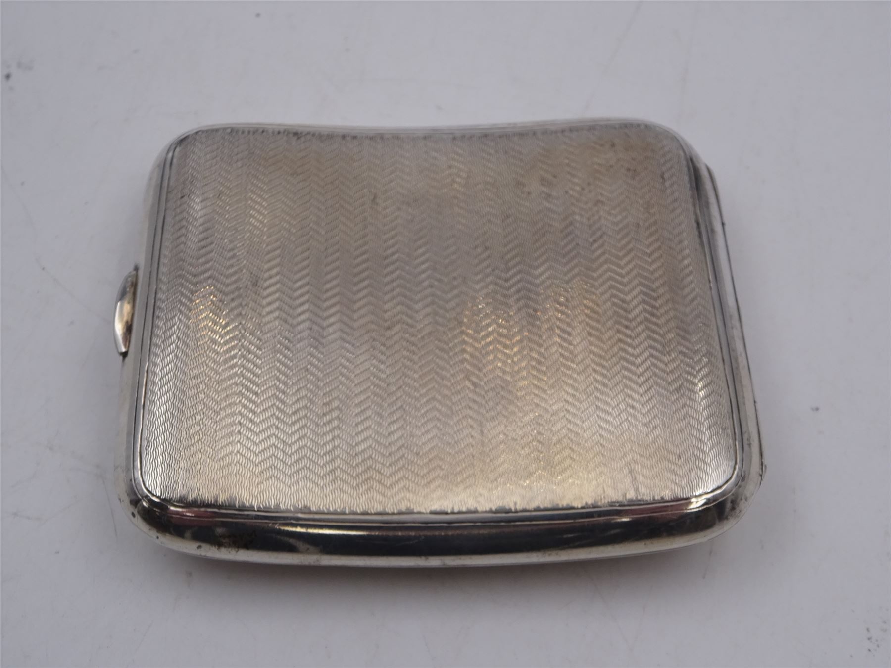 Edwardian silver cigarette case, of rectangular form with engine turned decoration throughout and engraved cartouche to front cover, hallmarked Colen Hewer Cheshire, Chester 1906, H8.6cm