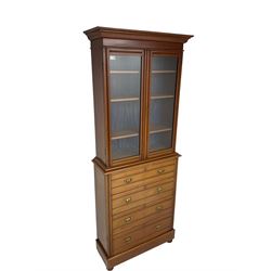 Edwardian walnut bookcase on chest, shallow form, two glazed doors above four drawers, plinth base on turned feet