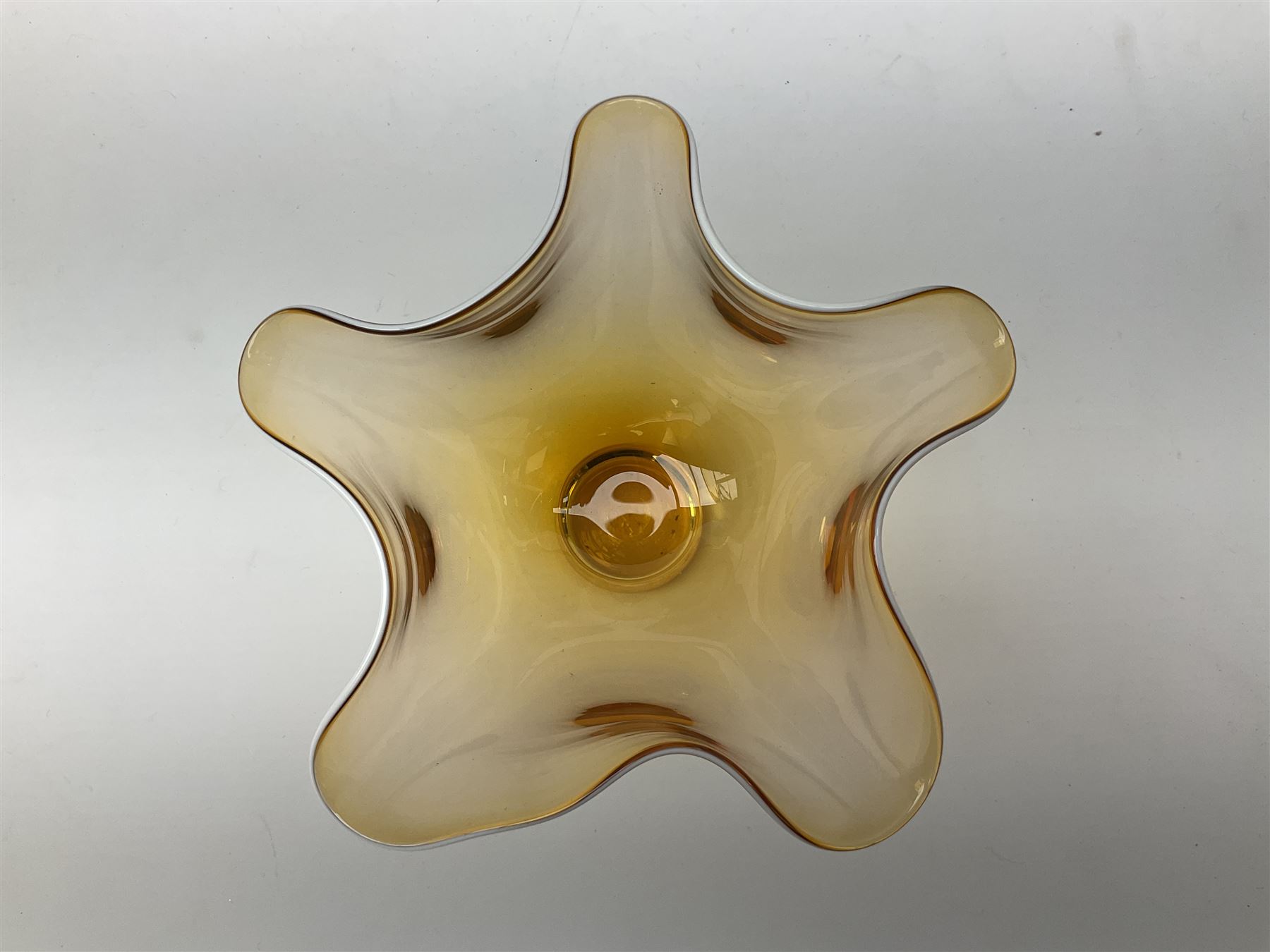 Gillies Jones orange glass bowl with crimped white rim upon a pedestal foot, H11.5cm