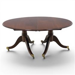 Gott's Pickering - Quality Georgian design rosewood twin pillar extending dining table, with additional leaf, oval form raised on turned columns with tripod legs on cast brass sockets and castors, complete with brass coupling forks, length 164cm without leaf