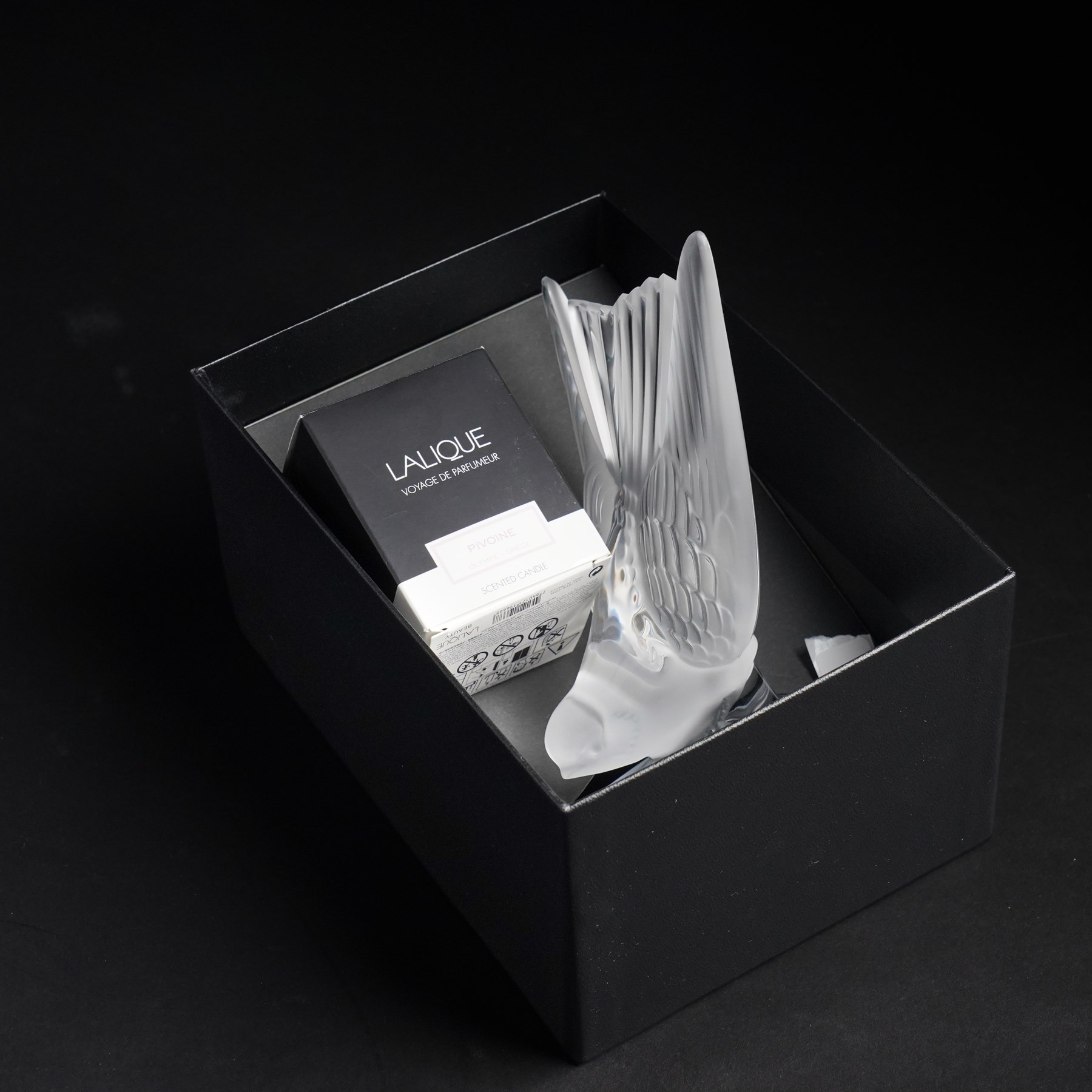 Lalique model of a swallow frosted glass bookend, inscribed 'Lalique France' H15.5, and 'pivoine' scented candle in box (2)