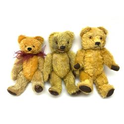 Two Irish Tara 'Laughing' bears c1950s each with mechanical opening mouth, one operated by sliding button to the back of the head, the other with squeeze and squeak action, and another Tara bear with jointed head, closed mouth and growler mechanism; all with plush body, glass eyes and vertically stitched nose and jointed limbs with rexine covered pads, largest H15