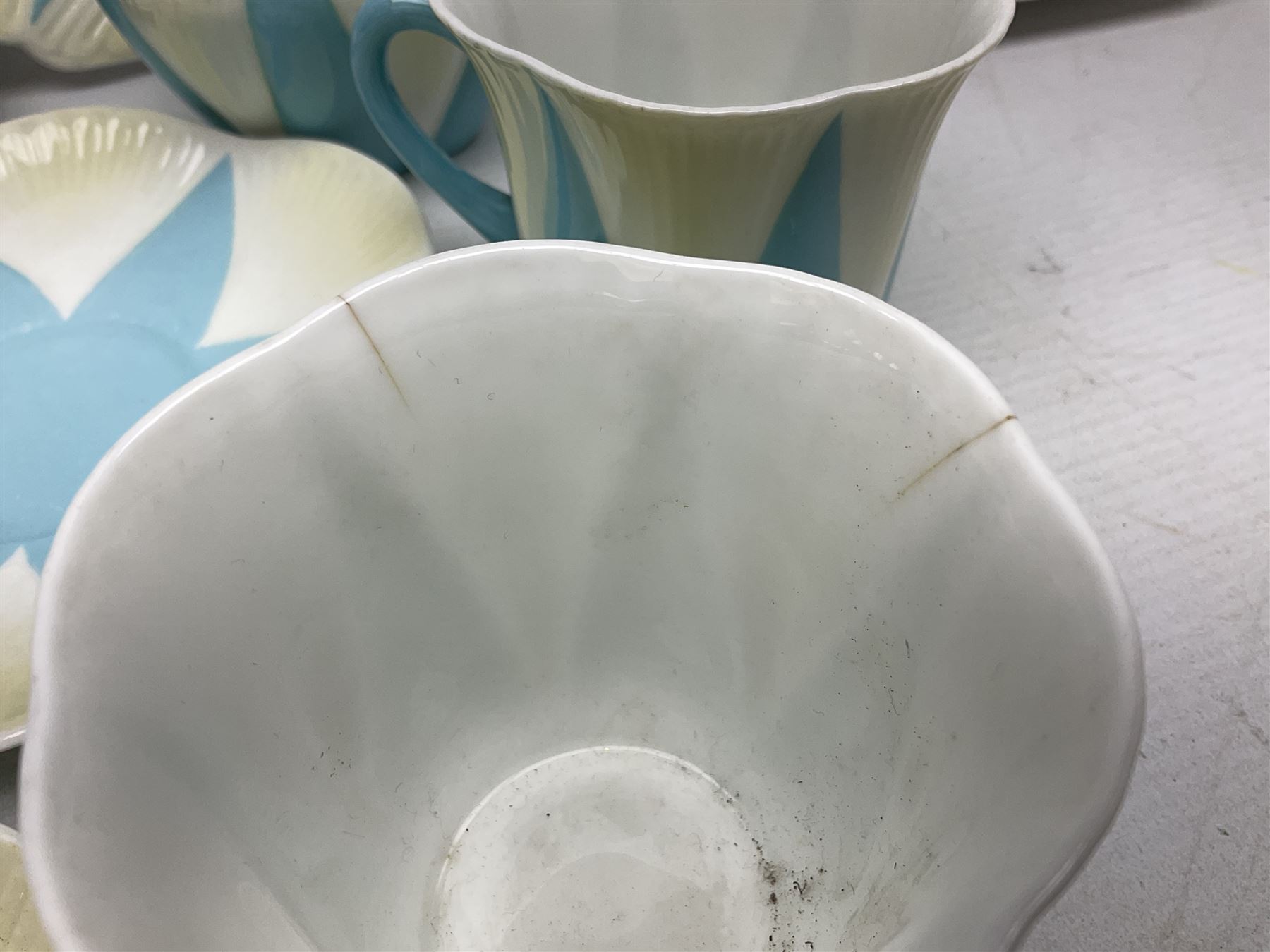 Shelley Dainty pattern tea wares, of lobed form with blue star decoration on merging white and yellow ground, comprising five teacups, five saucers, six tea plates, milk jug and cake plate, all with printed green mark beneath, some with painted pattern no 11770