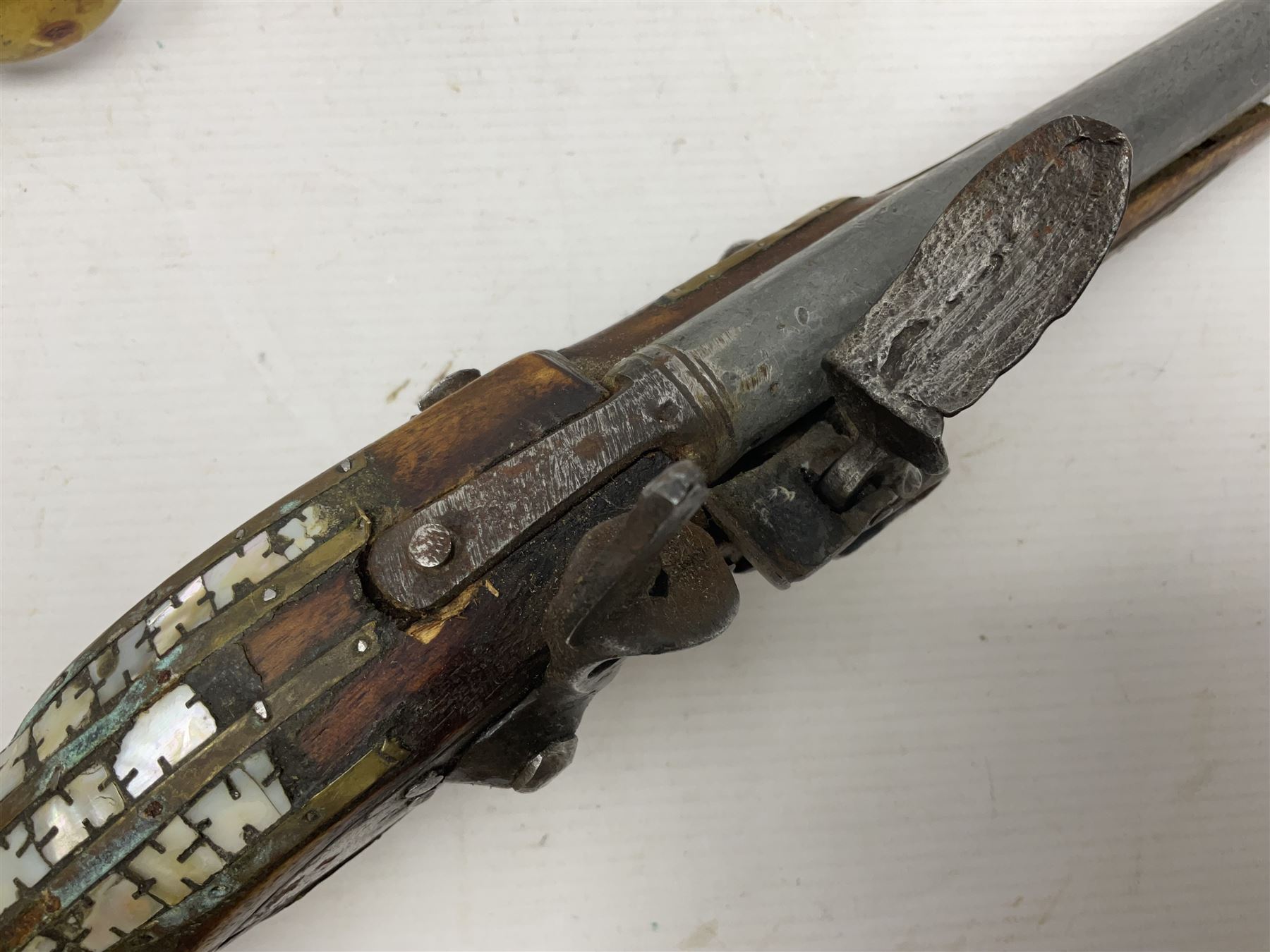 Modern non-firing reproduction Tower flintlock pistol marked with crowned GR and Tower to the lock, brass skull crusher butt and fittings L40cm overall; another Indian/Moorish reproduction flintlock pistol with mother-of-pearl inlay; and a modern die-cast replica Colt style revolver (3)