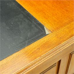 20th century oak kneehole desk, rectangular black leather inset top, above a single frieze drawer, flanked by two pedestals with slides and drawers, panelled sides and back 