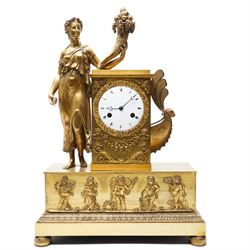 Empire period-gilt brass early 19th century French figural mantel clock c1820, the case su...