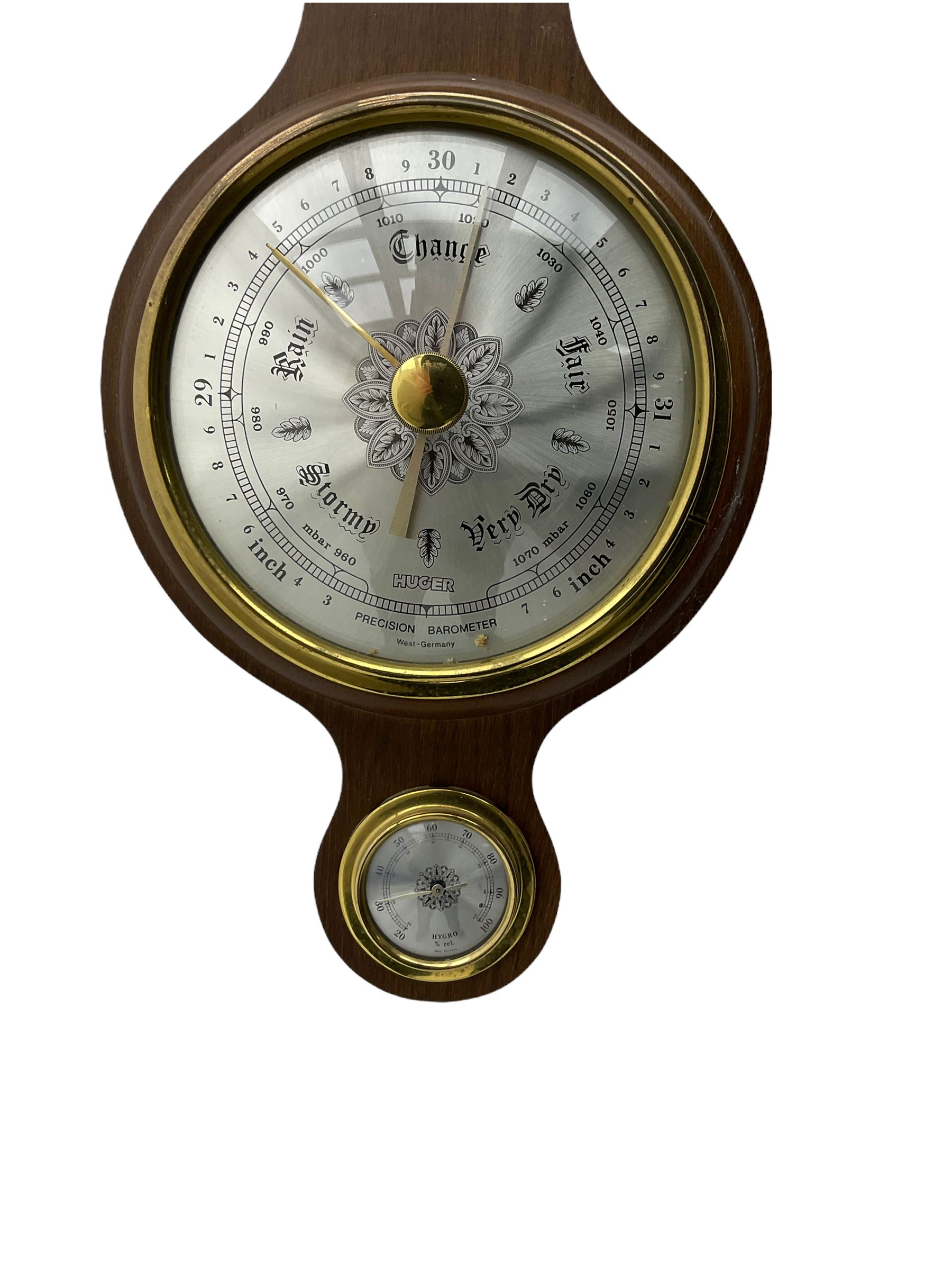 A contemporary German Aneroid barometer in a mahogany effect case with a broken pediment and