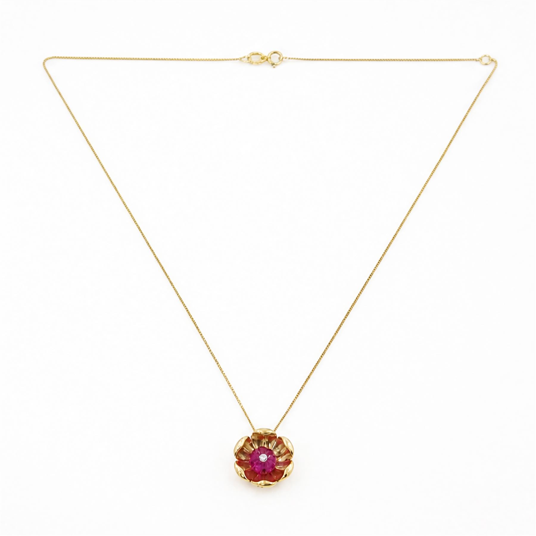 14ct gold ruby and diamond flower head pendant, carved ruby set with a single round brilliant cut diamond, on a 9ct gold trace link chain necklace