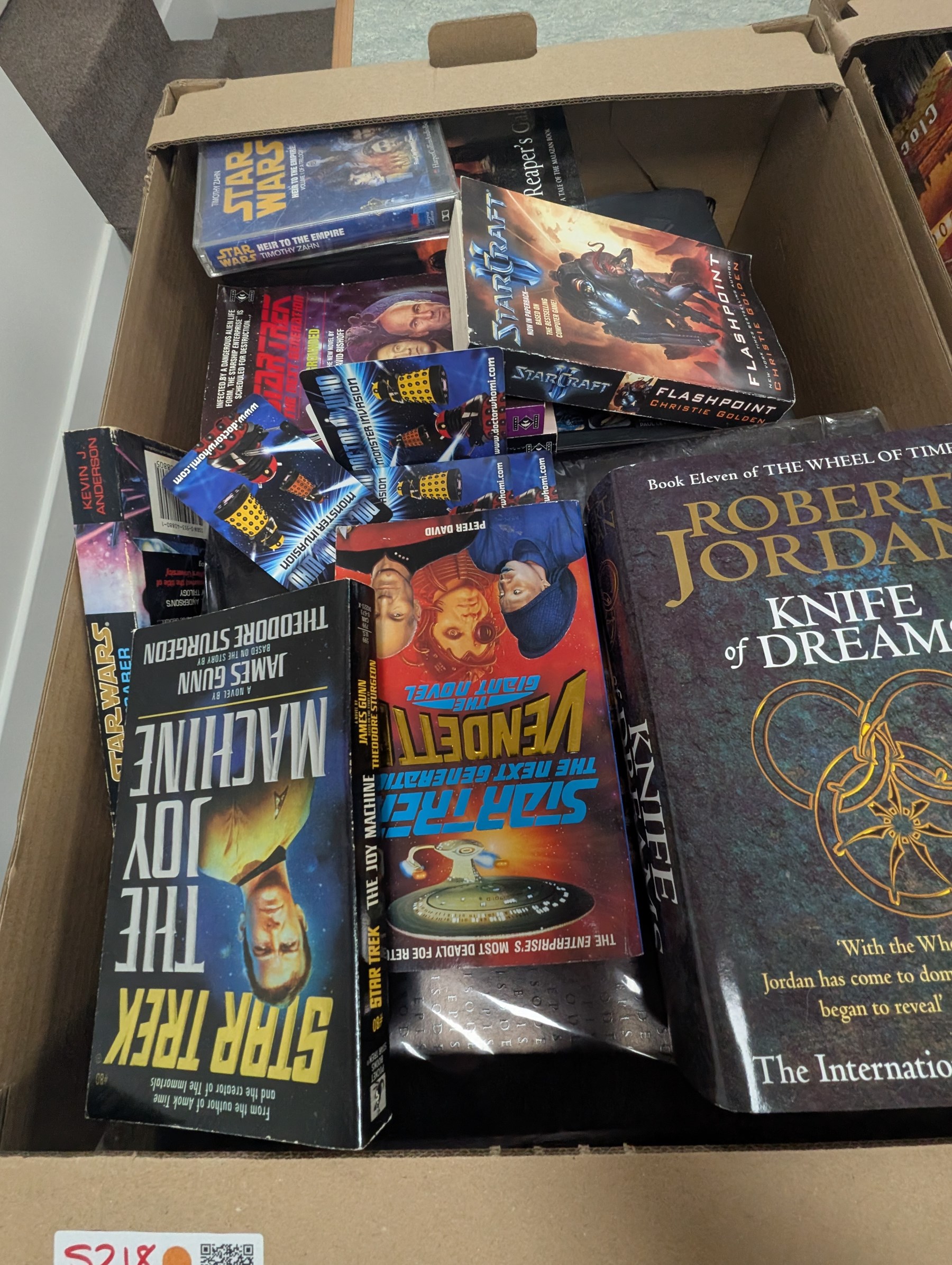 Large collection of Sci-Fi books and ephemera, including Star Wars, Star Trek and Doctor Who novels, in four boxes