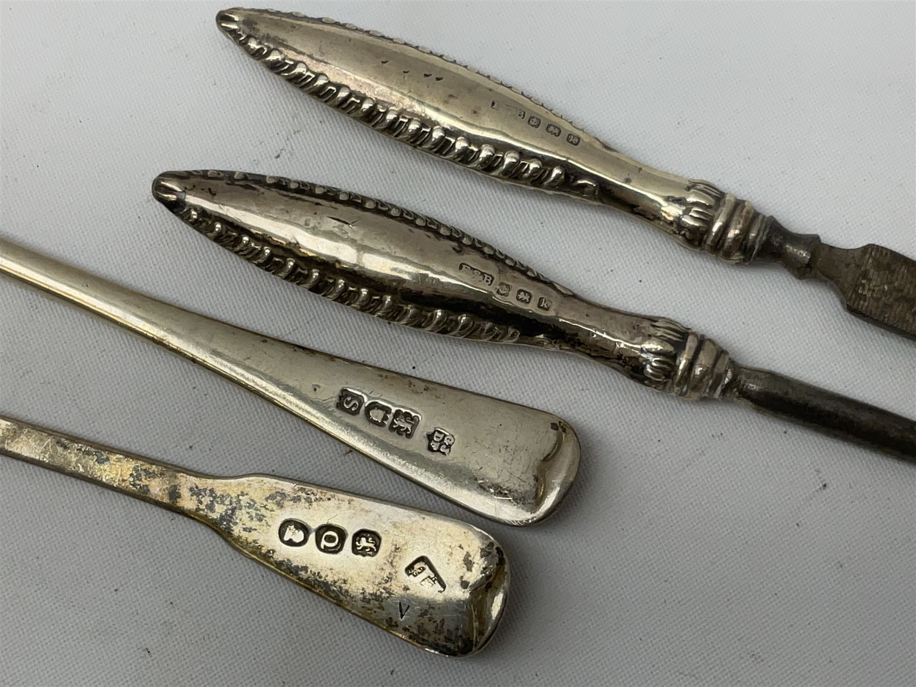 Small group of silver, to include Georgian Fiddle pattern teaspoon, later teaspoon, sugar tongs, etc., all hallmarked, approximate weighable silver 59 grams, approximate gross weight 113 grams
