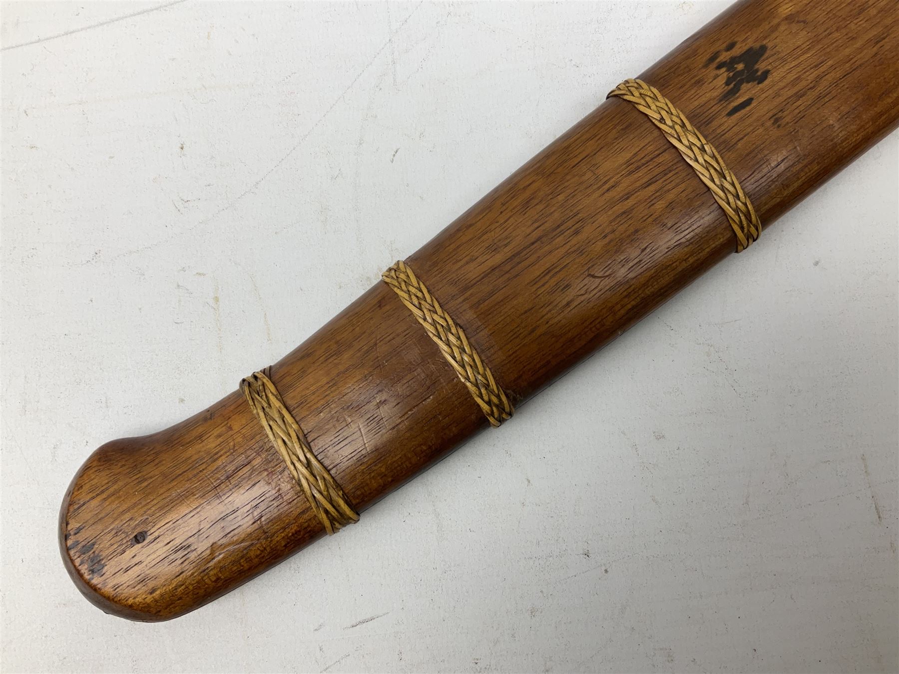 Malaysian parang survival knife the 29cm steel blade with character marks, cane bound teak grip carved with a stylised turtle head to the pommel, with matching teak scabbard L46cm overall