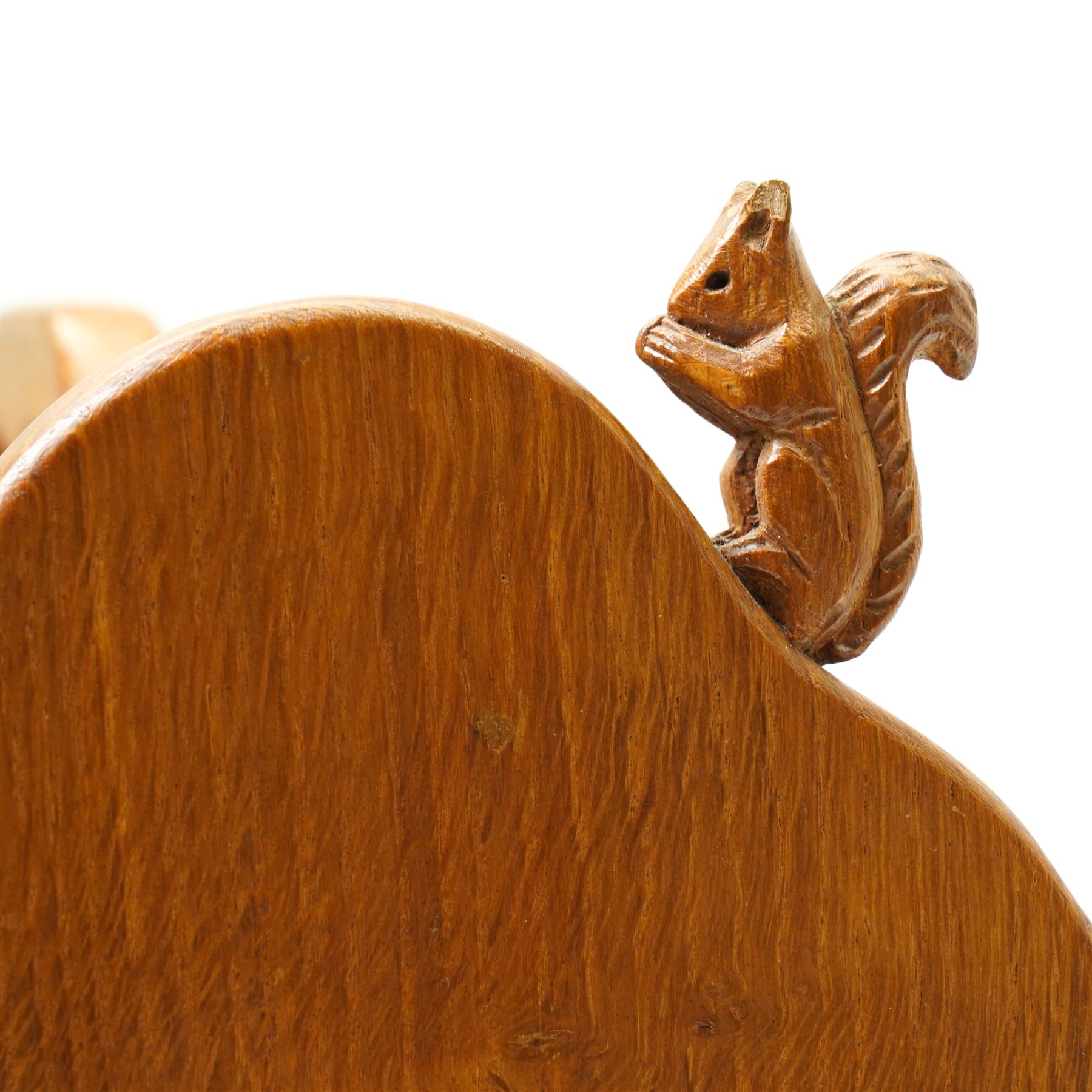 Squirrelman - oak magazine rack, the shaped ends enclosing a central slatted support with carrying aperture, enclosed by slatted sides and base, with carved squirrel signature, by Wilfrid Hutchinson of Husthwaite