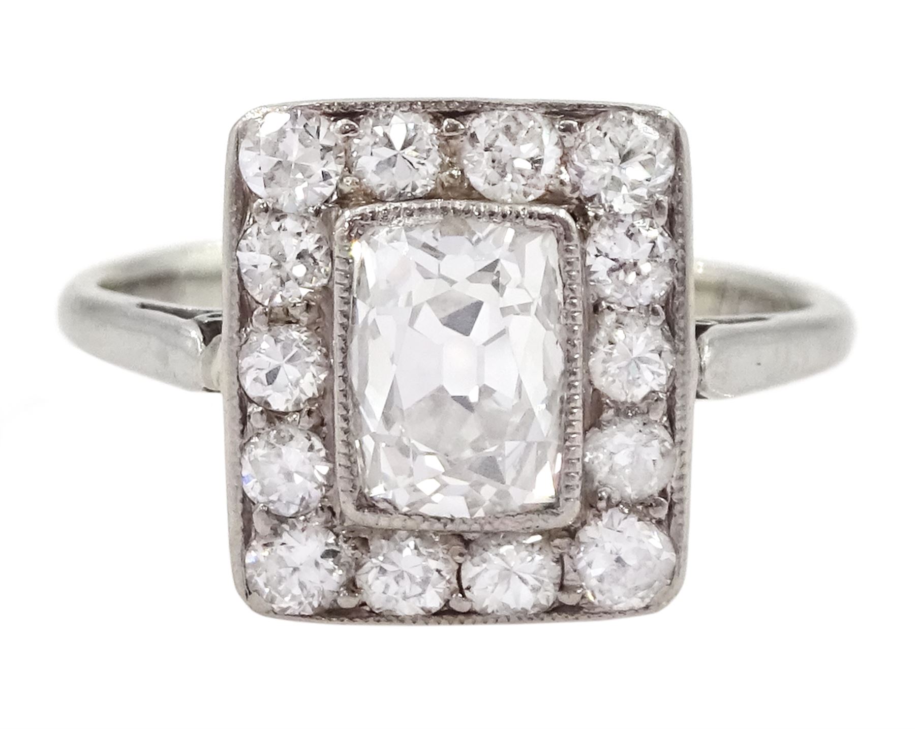 Art Deco platinum and white gold milgrain set diamond ring, circa 1920's, the central cushion cut diamond of approx 0.90 carat, with old cut diamond surround, total diamond weight approx 1.10 carat