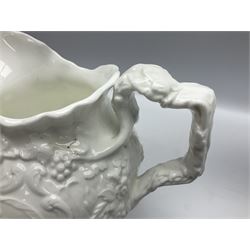 Pair of early/mid 19th century Copeland and Garrett white glazed pitchers, modelled in the Georgian style and moulded with the figures of Venus the Roman Goddess of Love, and Aurora the Roman Goddess of Dawn, within C scroll borders and foliate surround, the naturalistically modelled handle leading to a fruiting vine beneath the rim, upon a spreading base moulded with seashells, with printed green crowned wreath mark beneath, H20cm