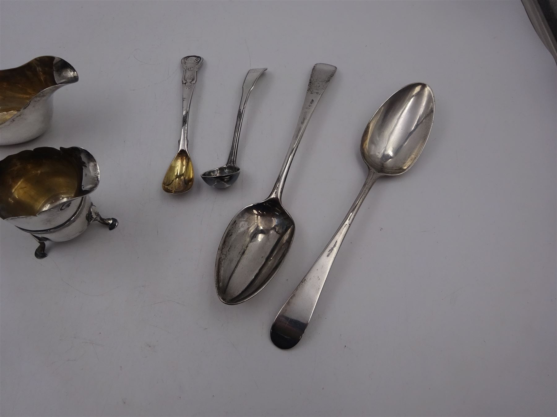 Pair of Georgian silver Old English pattern spoons, hallmarked Thomas Wallis II, London 1791, together with a silver sauce boat, silver cream jug and two other silver spoons, all hallmarked 