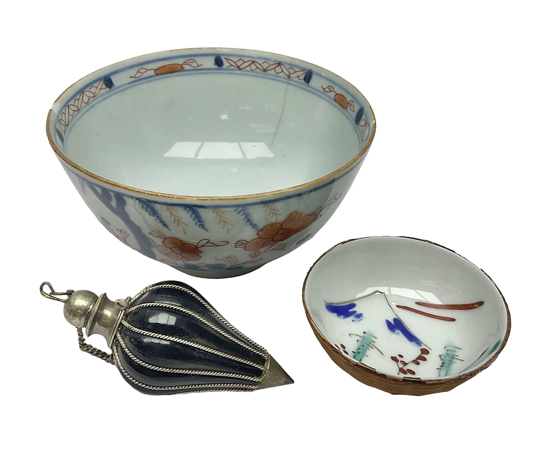 Chinese ceramic bowl, painted with floral and foliate decoration on a white ground, together with a similar much smaller Chinese bowl, painted with mountain scene to centre and covered by basket weave to exterior and a white metal mounted pear shaped scent bottle, largest bowl D11cm
