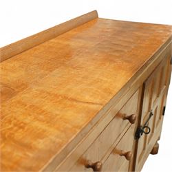 Mouseman - oak sideboard rectangular adzed top with raised back over three central drawers and two flanking cupboards, enclosed by panelled doors with wrought metal fixtures, the canted upright carved with mouse signature, on octagonal feet, by the workshop of Robert Thompson, Kilburn