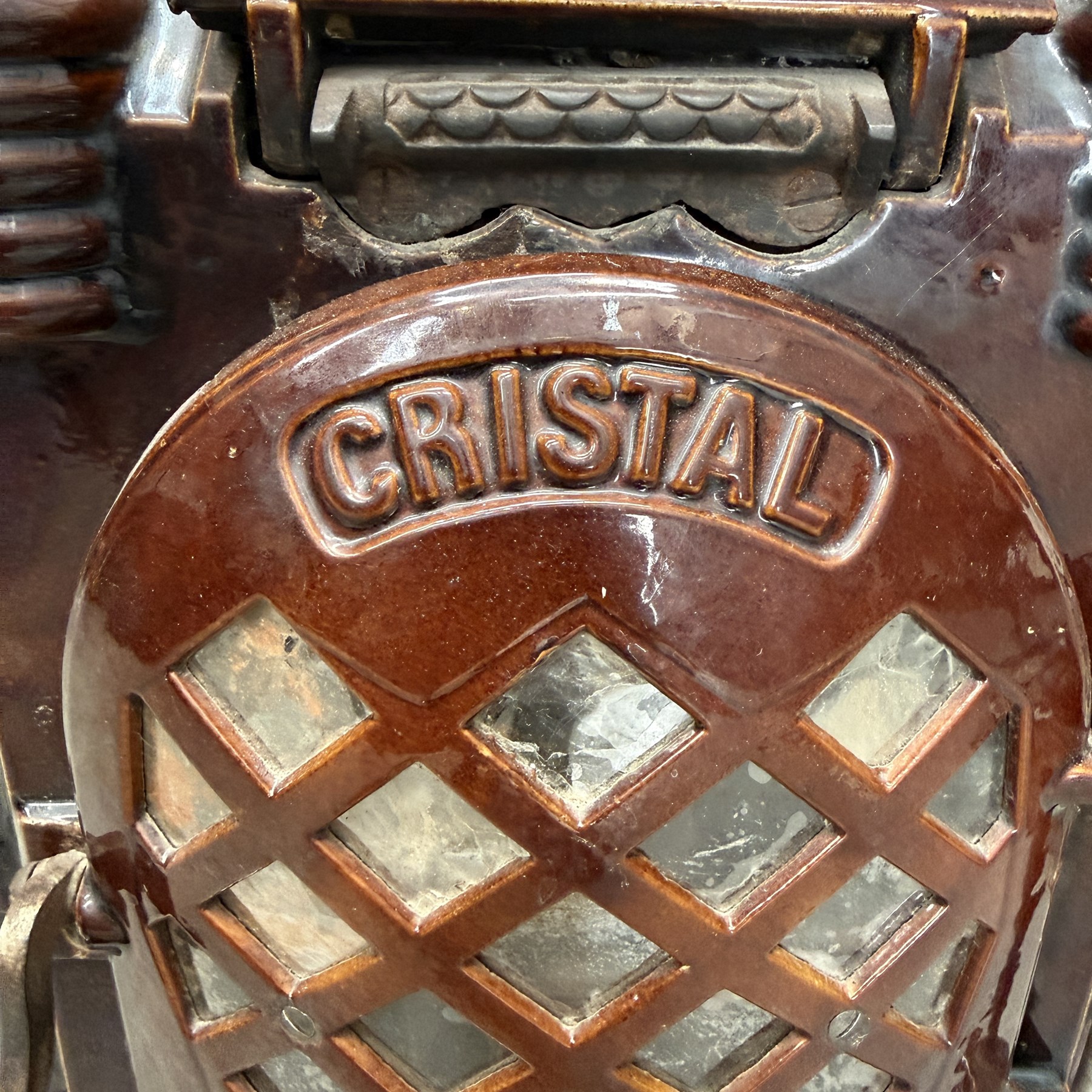 Deville & Cie of Charleville - early 20th century Art Deco cast iron and burgundy enamel 'Cristal' wood burning stove, hinged vent over lattice glazed door and ash drawer, on shaped geometric base, circa 1920