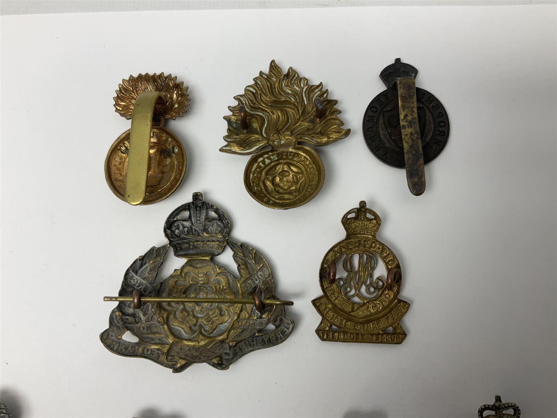 Nineteen Yeomanry metal cap badges including Derbyshire, Northamptonshire, Essex, Glamorgan, Staffordshire, City of London, Surrey, Shropshire, Hertfordshire etc; together with eleven Fusiliers badges including Lancashire, Royal Welch, Northumberland etc (30)