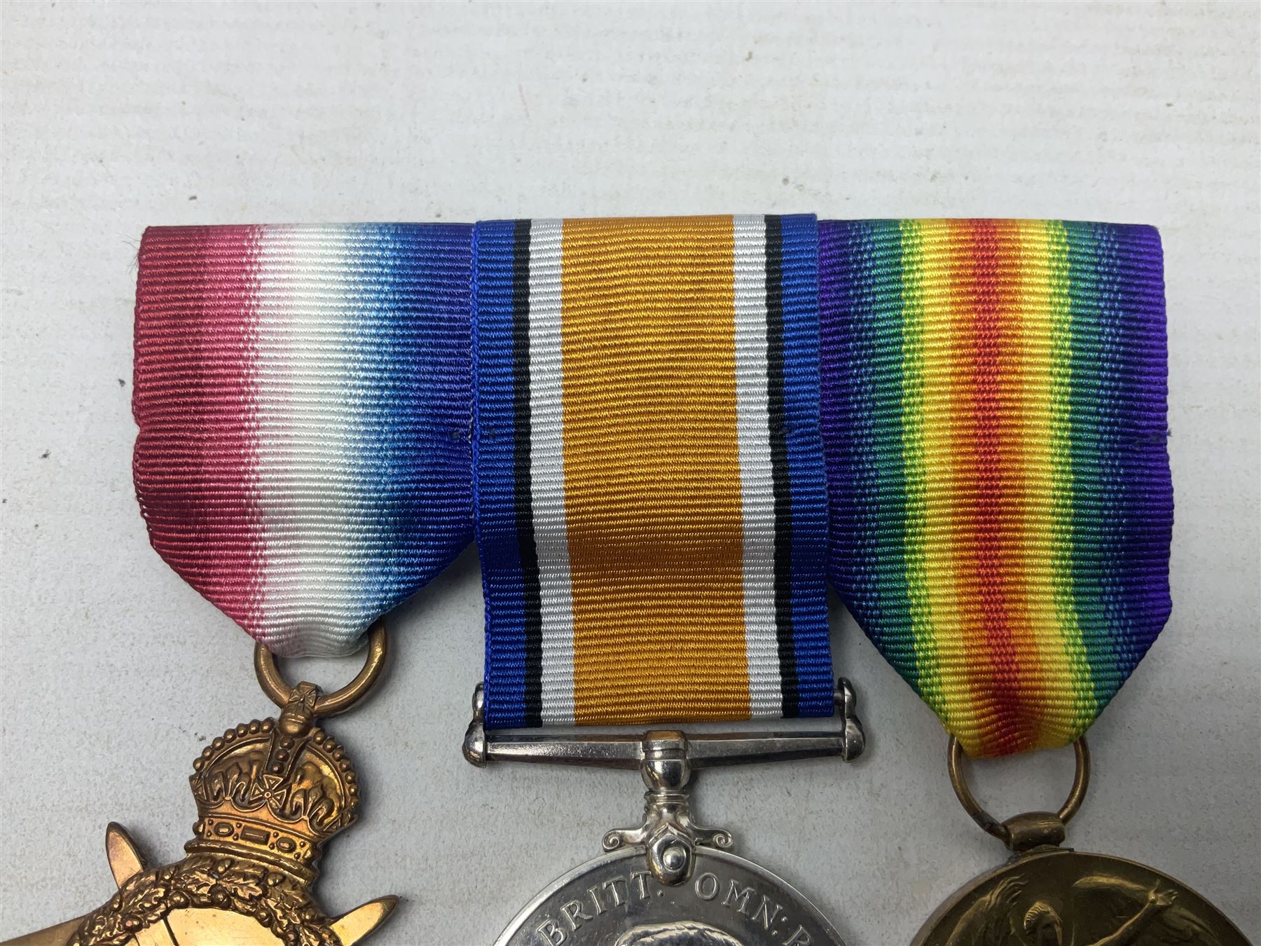 WW1 KIA group of three medals comprising British War Medal, 1914-15 Star and Victory Medal awarded to 9069 Cpl. J. Mayhew Glouc. R.; with ribbons; displayed on modern bar, and photograph of recipient in uniform; some biographical details