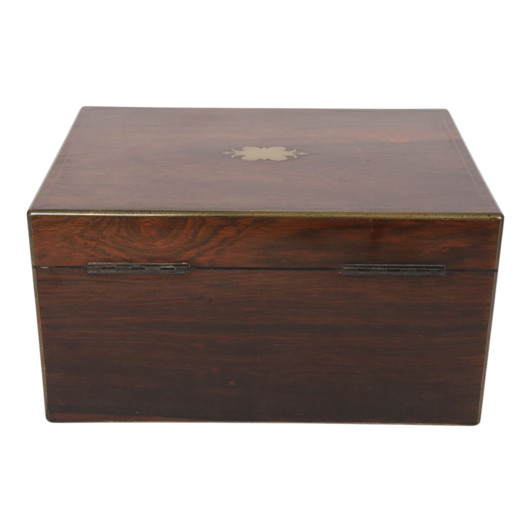  Victorian brass inlaid rosewood dressing table box, retailed by F.L. Hausburg, Liverpool, the lid centred by a brass cartouche, opening to reveal letter store to lid underside, above a fitted interior, with ten mounted cut glass jars, bottles and manicure set, within lift out leather trays, above jewellery drawer, with key, H17cm D24cm