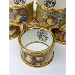 A set of ten Kingsley Enamel fruit painted napkin rings with gold coloured mounts, signed C Hugh, D4.5cm. 