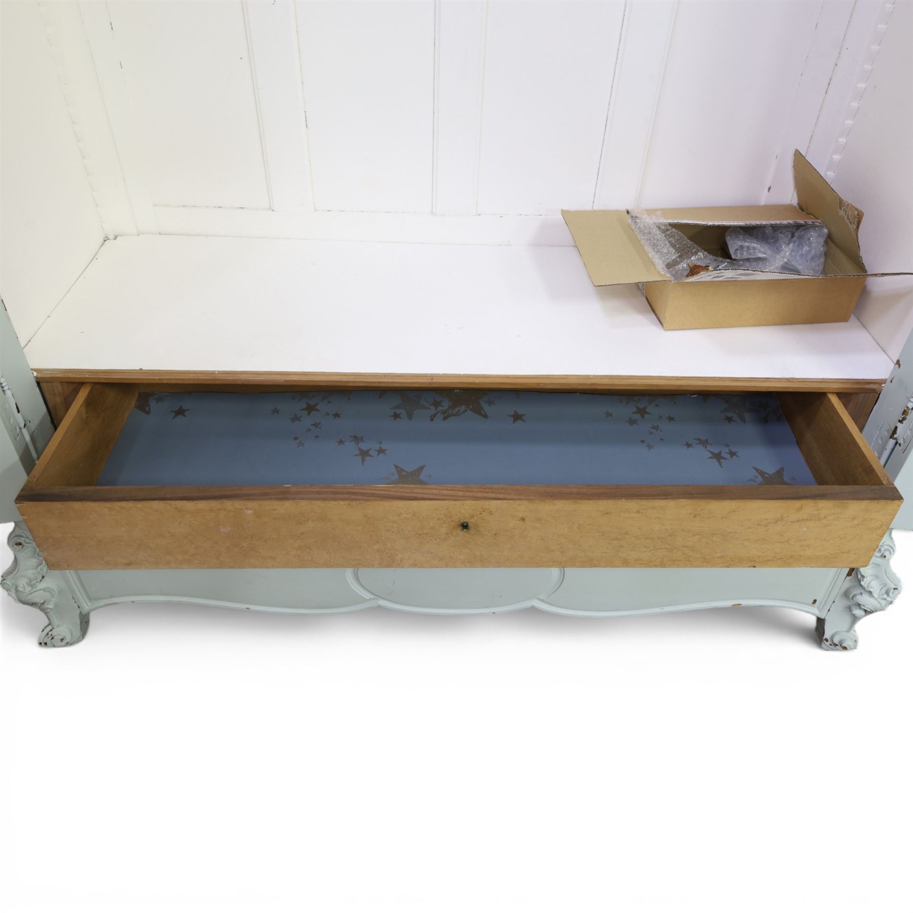 French Louis XV style pale blue painted armoire, with carved floral and foliate crest over a shaped moulded cornice, fitted with two bevelled mirror panel doors enclosing hanging space and drawer, above shaped apron, raised on carved cabriole supports