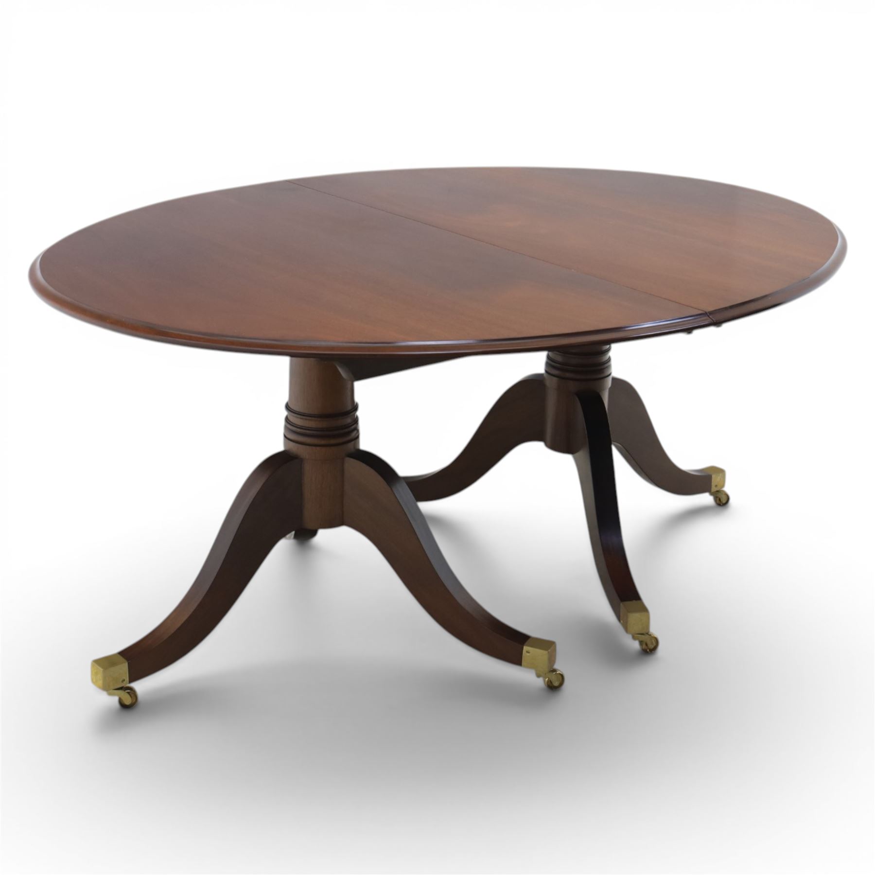Gott's Pickering - Quality Georgian design rosewood twin pillar extending dining table, with additional leaf, oval form raised on turned columns with tripod legs on cast brass sockets and castors, complete with brass coupling forks, length 164cm without leaf