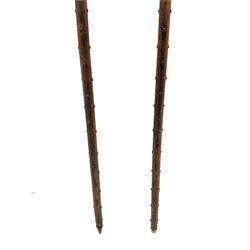 Large continental steel halberd axe the engraved blade with cast sunburst centre and long studded ash handle L219cm; and another halberd with plain ribbed blade and studded ash handle with ground spike (2)