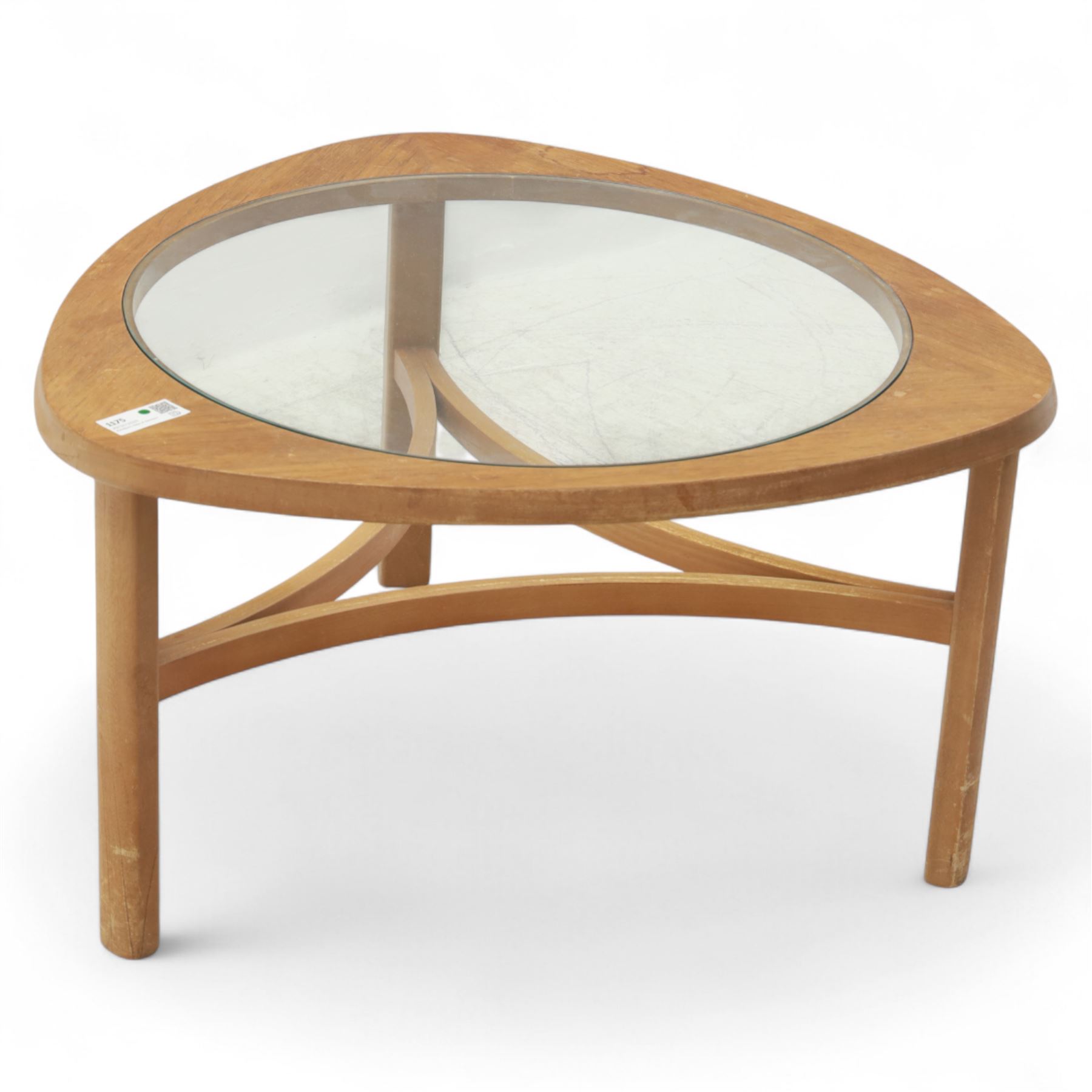 Mid-20th century teak and glass coffee table, of triangular form with rounded corners, inset circular glass top over curved stretcher base