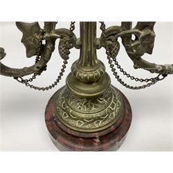 Pair of 19th century brass candelabra, each with circular spreading marble base leading to a shaped and tapering column with bird finial, flanked by twin curved and foliate detailed branches with sockets above shaped drip pans, H31cm