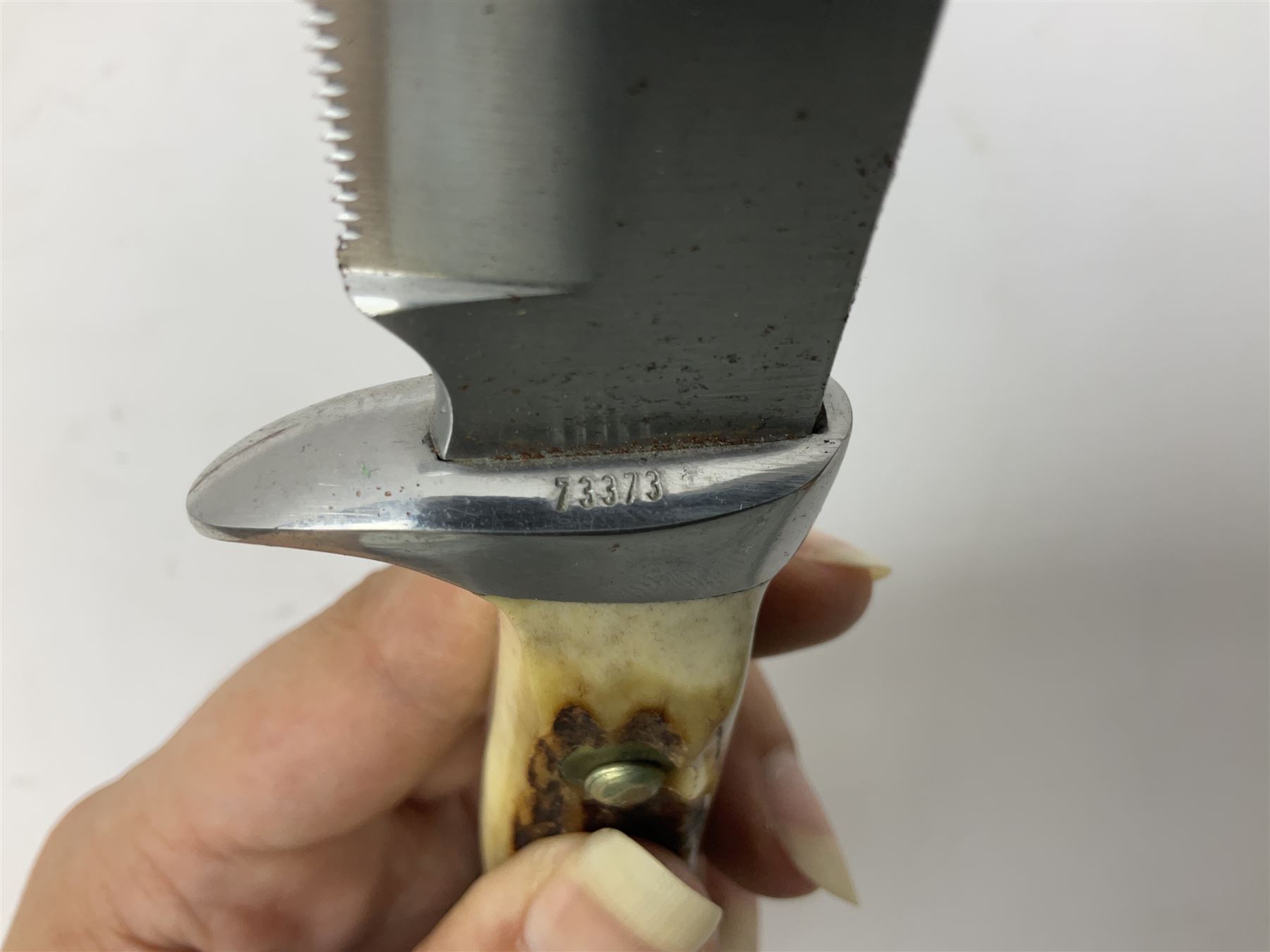 German Original Puma-Bowie knife, with maker's name and number 6396 to the 16.5cm blade, stamped number 73373 to the guard, antler grip, in original hard plastic case with brown leather sheath, also marked Puma