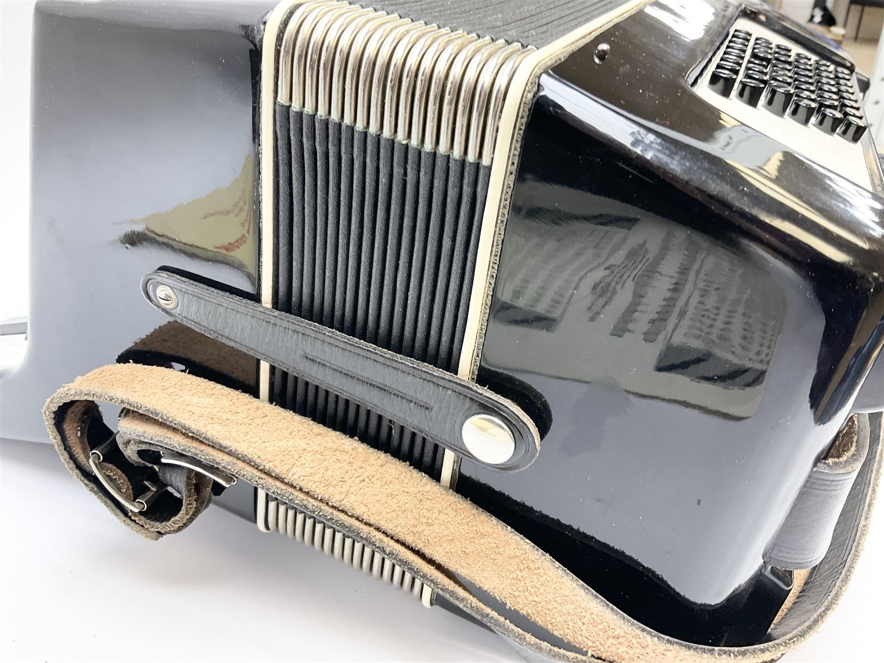 GDR Firotti piano accordion with black and silver case, sixteen keys and forty-eight buttons L38cm; in simulated reptile skin case with sheet music