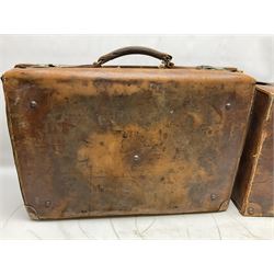 Early 20th century leather suitcase marked to the top 'Major P.M. Newton R.E. Crossways, Bridlington, East Yorkshire' 60 x 40cm; another similar leather suitcase marked W.D. to the lid; three post-WW2 respirators; and three unopened pairs of British Army N.B.C. (Nuclear Biological Chemical) No.1 Mk.III Trousers Protective (8)