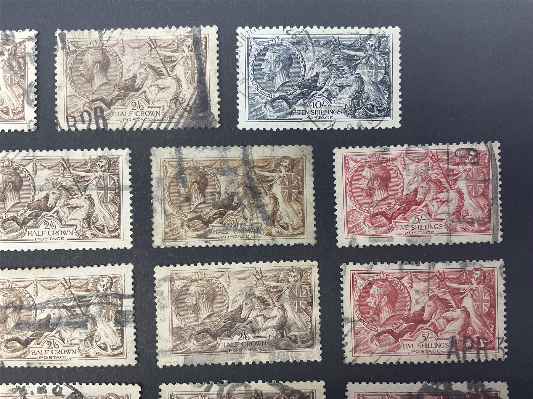 Great Britain King George V seahorse stamps, comprising fourteen half crown, seven five shillings and two ten shillings, all used, all previously mounted