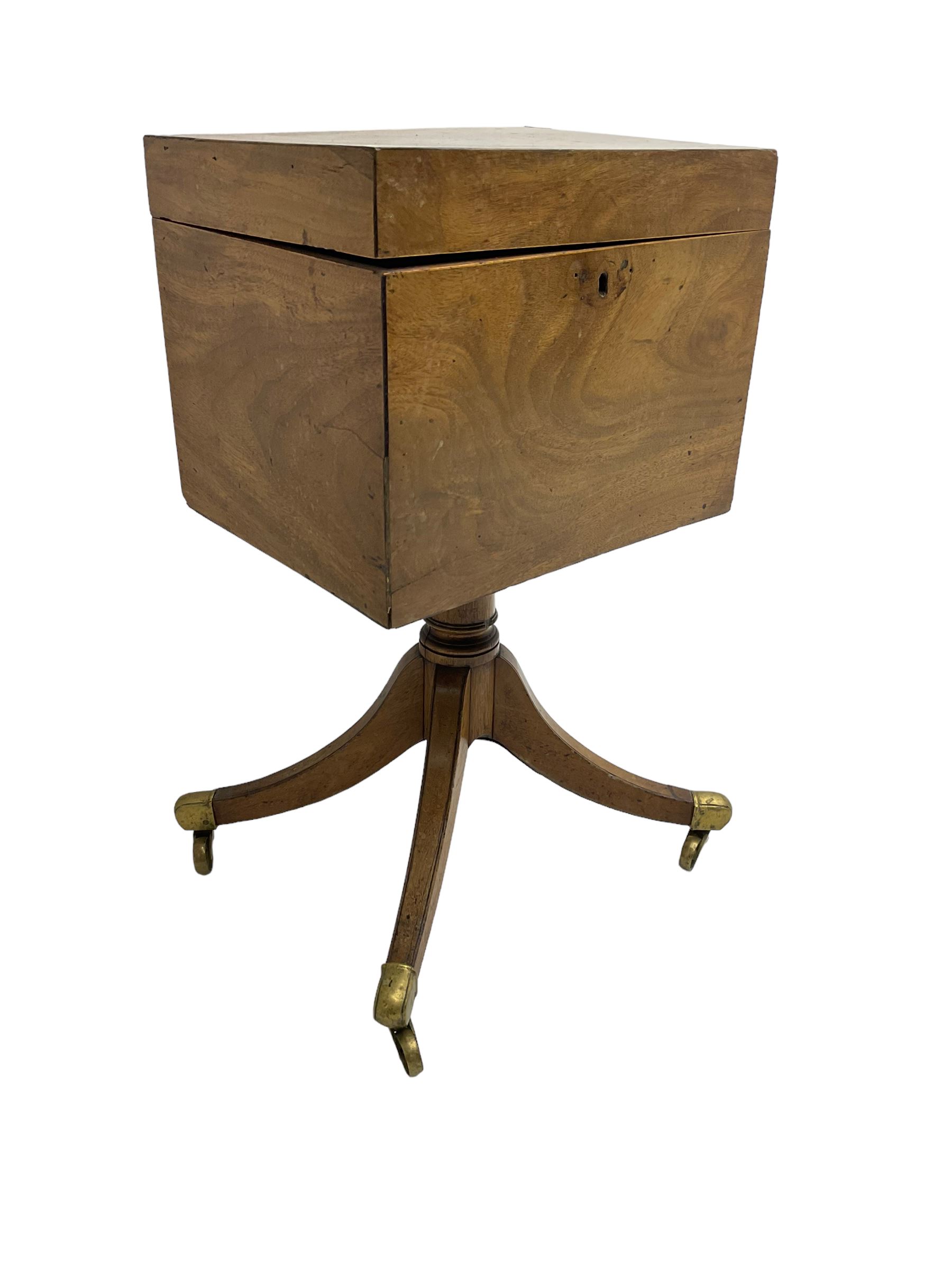 Regency mahogany cellarette on stand, rectangular top with hinged lid, raised on turned pedestal terminating in quadrupod base with brass cups and castors