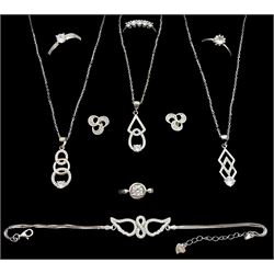 Three silver cubic zirconia pendant necklaces, silver wing design bracelet, pair of stud earrings and four silver cubic zirconia dress rings, all stamped 925 (9)