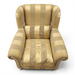 Alstons - 'Ixworth' armchair, upholstered in striped fabric, with loose seat cushions and scrolled arms, brass front castors